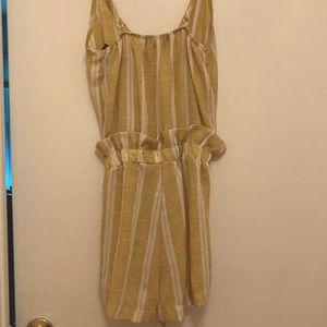 A stripped romper from See You Monday with a flare and tie at the waist.